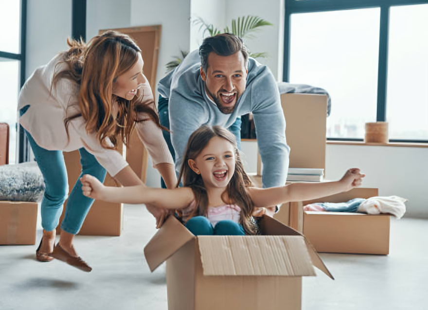 A joyful family moves into their new home, unpacking boxes and enjoying the moment together. Residential Moving Service