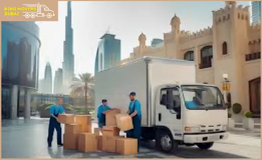 Two men load boxes into a moving truck, facilitating an cost of apartment moving in Dubai.