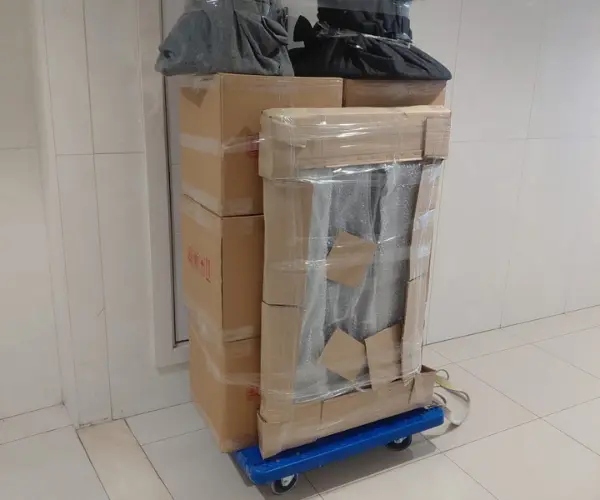 King Movers crew carrying a wrapped item in a Dubai villa