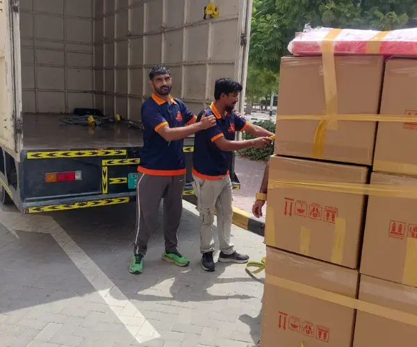 Crew moving boxes and furniture into a truck